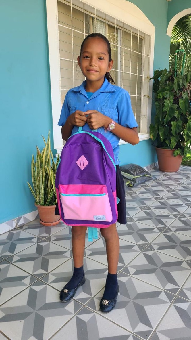 Children receiving backpacks